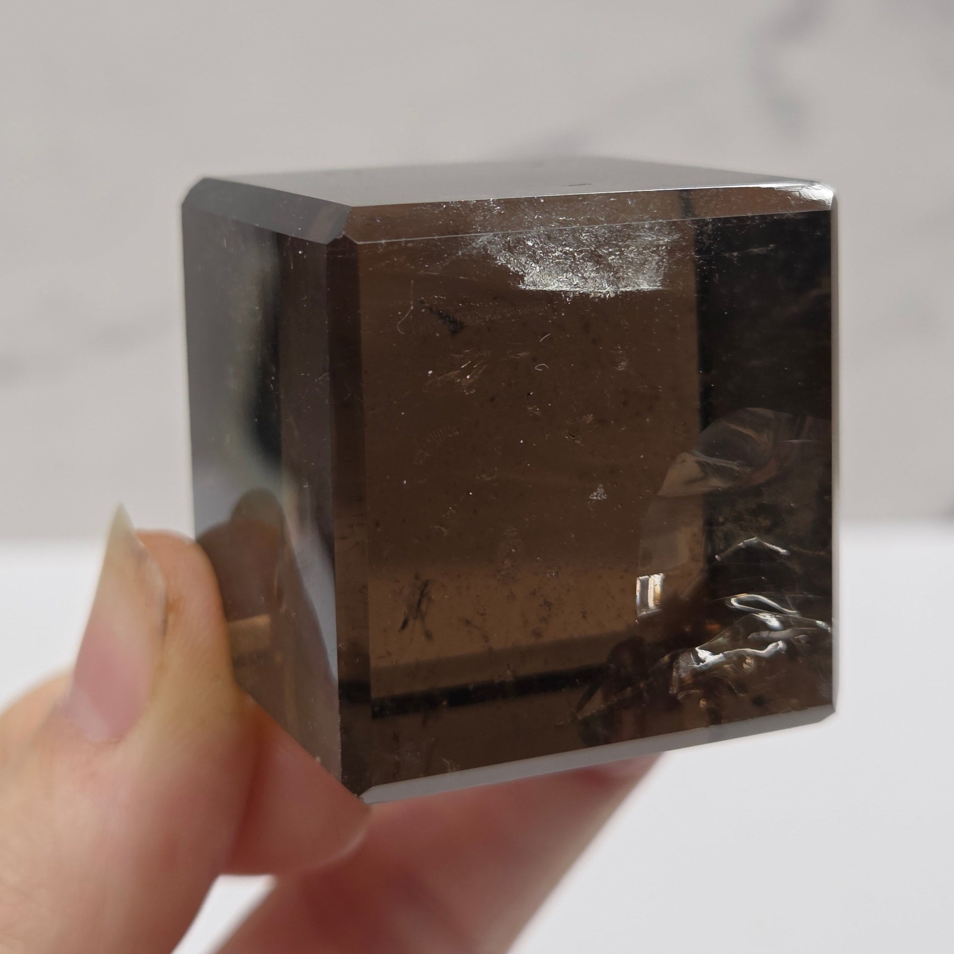 smoky quartz cube carving on a white background