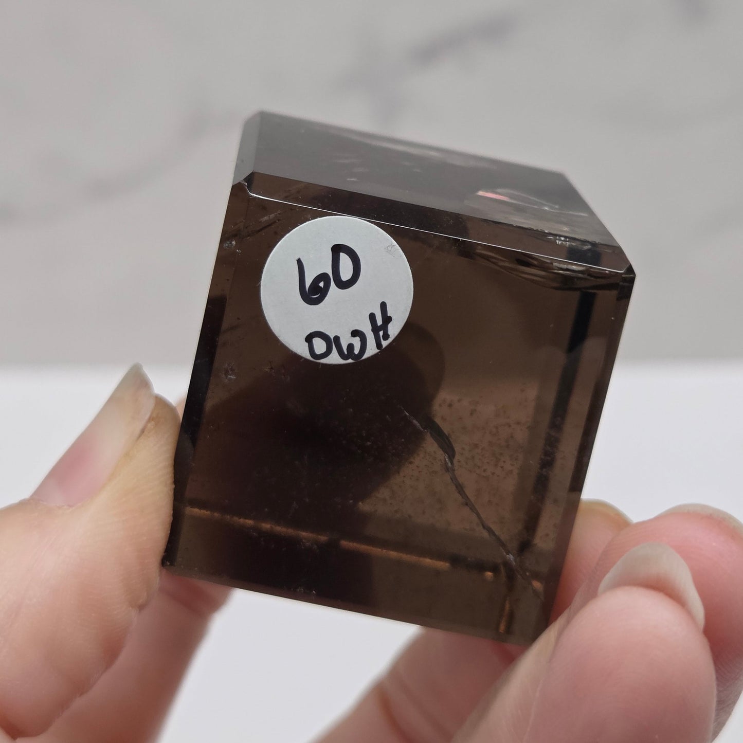 smoky quartz cube carving on a white background