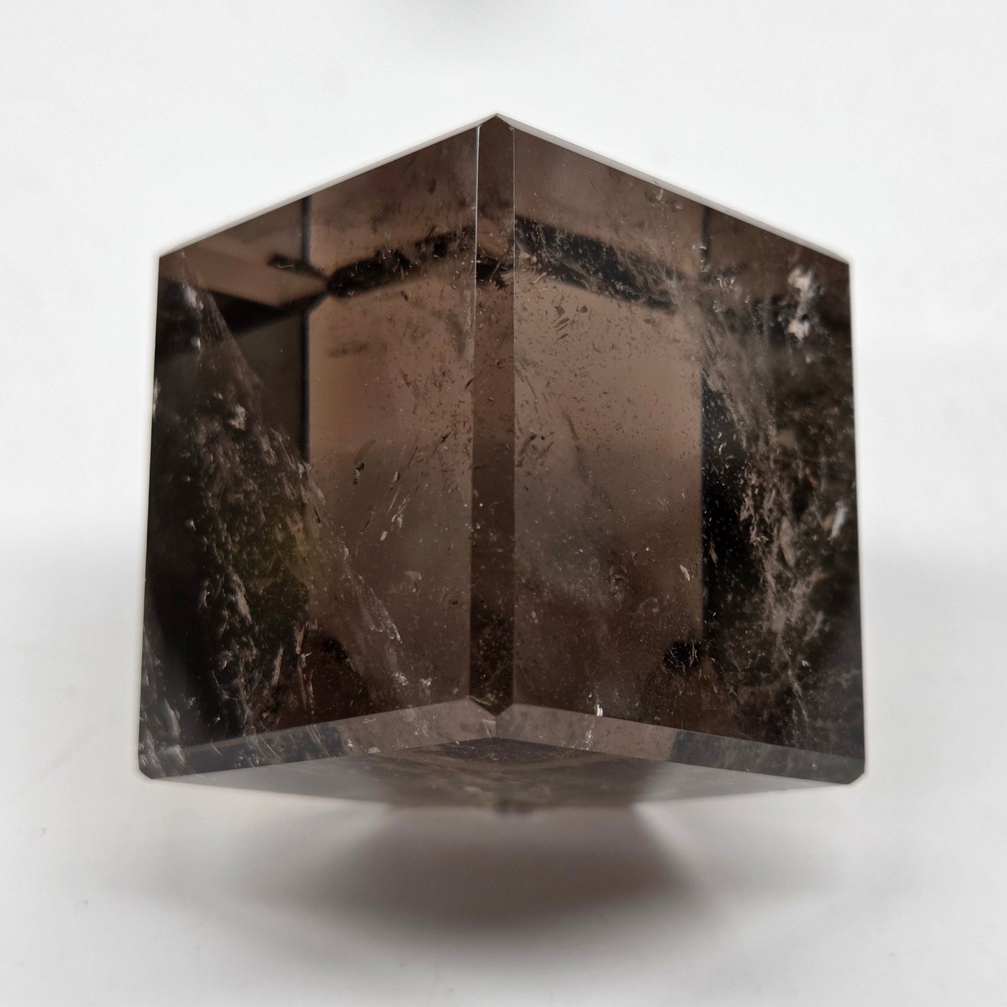 smoky quartz cube carving on a white background
