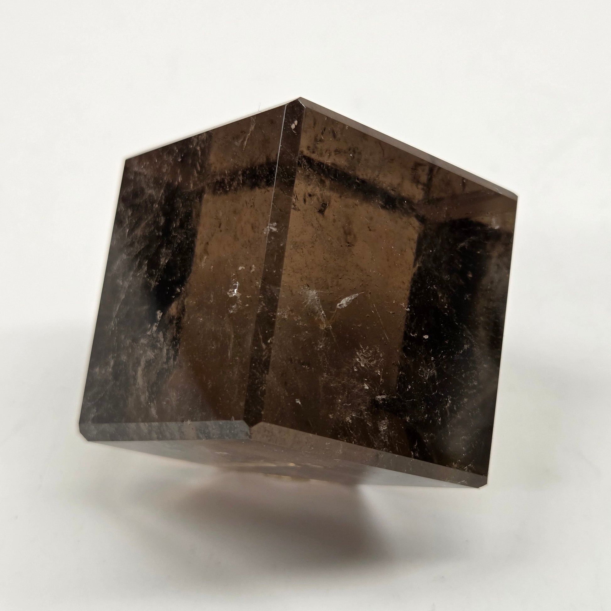 smoky quartz cube carving on a white background
