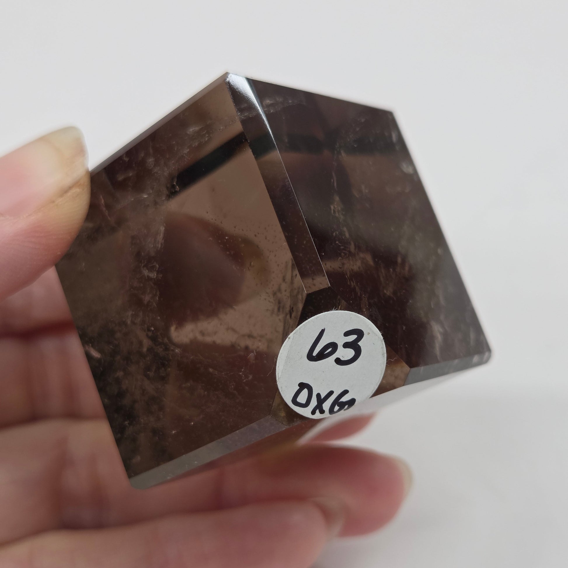 smoky quartz cube carving on a white background