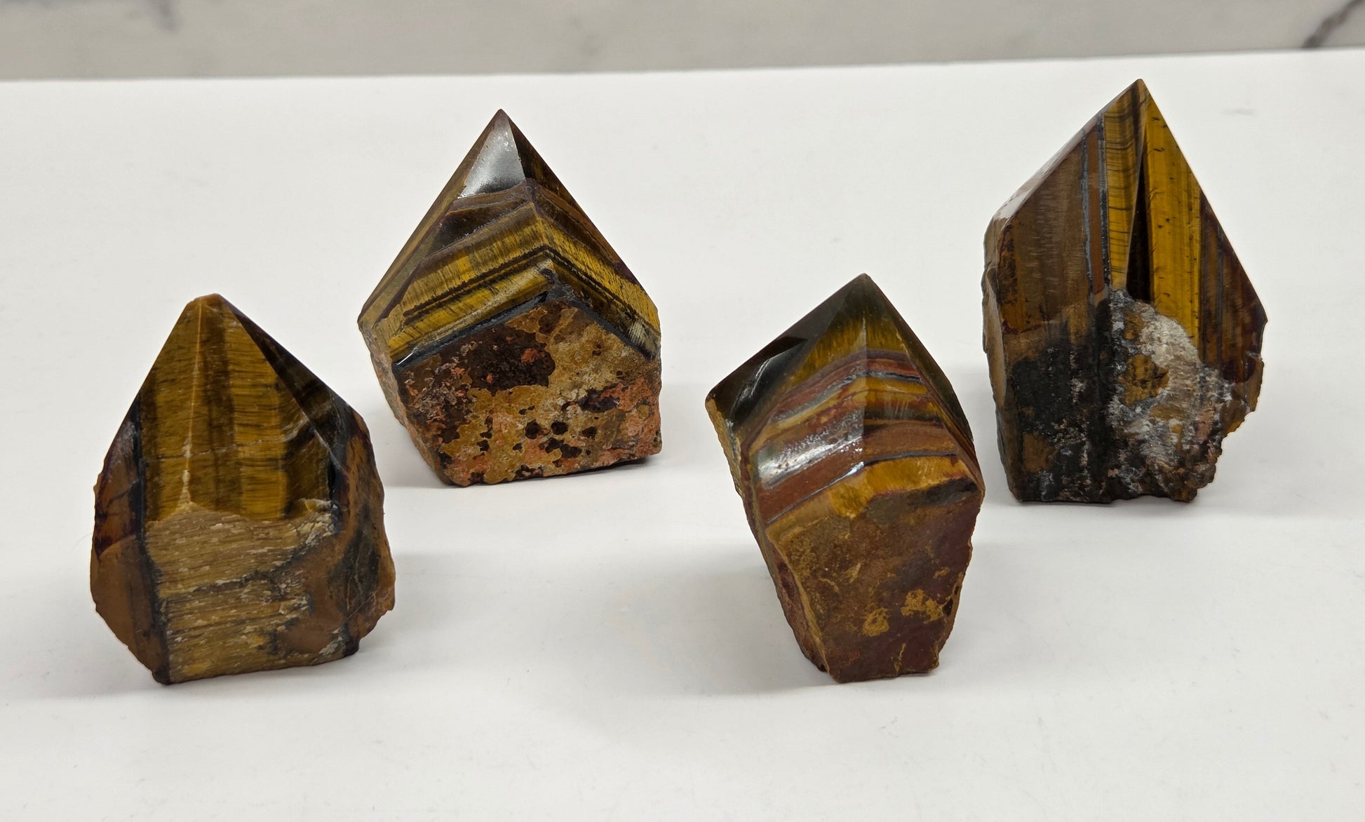 Tiger eye crystals on a white surface with a marble background