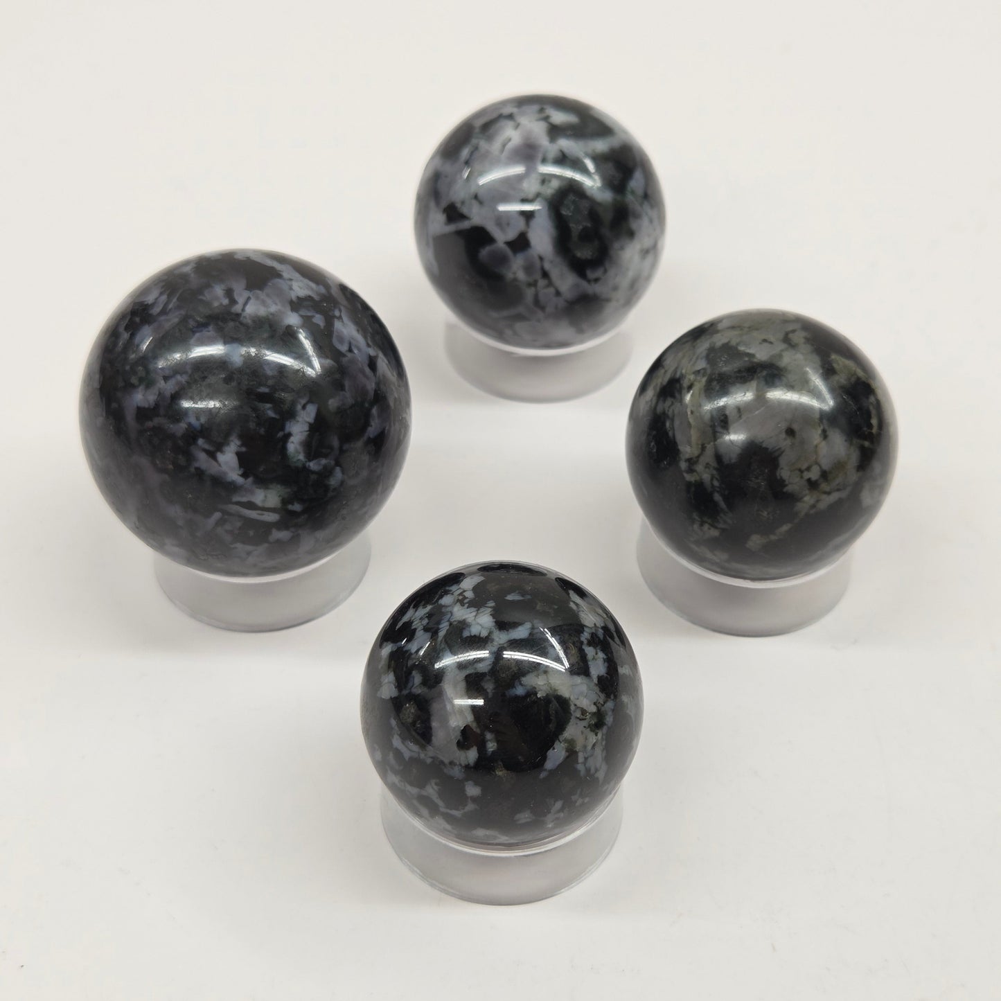 Four marbled crystal spheres on a white background