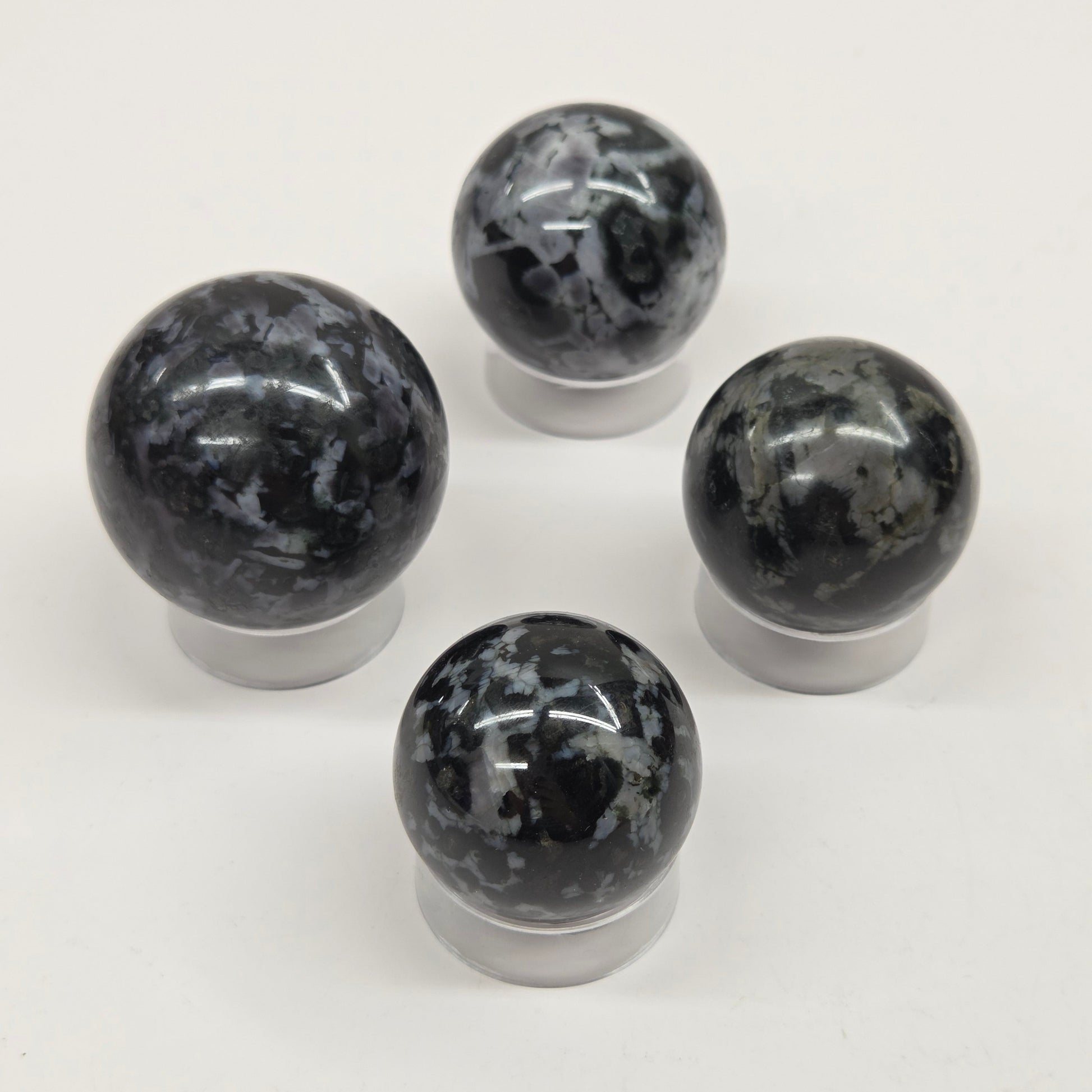 Four marbled crystal spheres on a white background