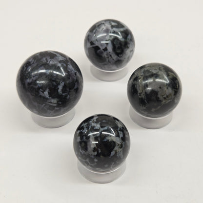 Four marbled crystal spheres on a white background