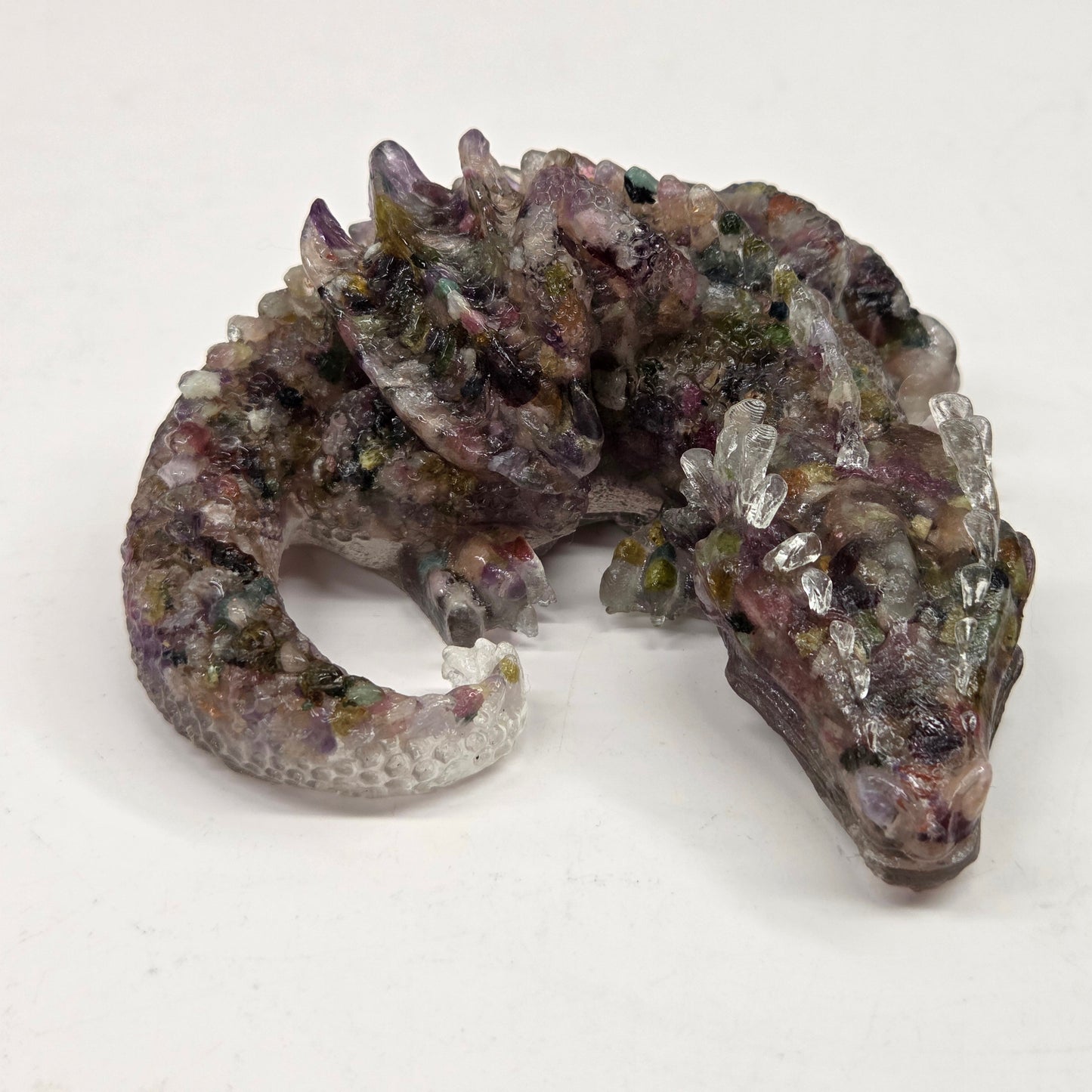 Resin with crystal chip carving of a dragon on a white background