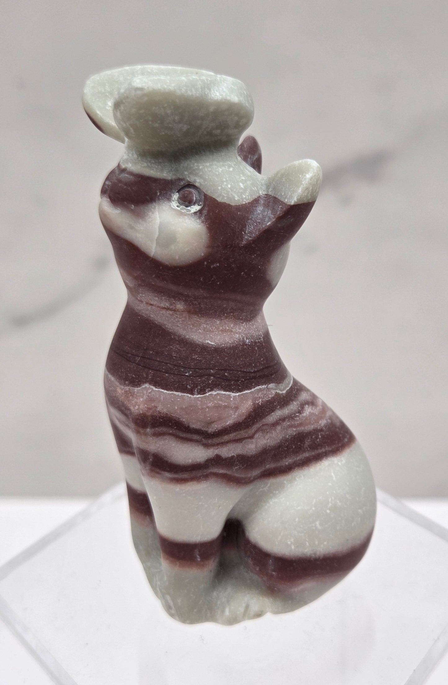 Banded Jasper crystal cat-shaped carving with a butterfly on the nose.