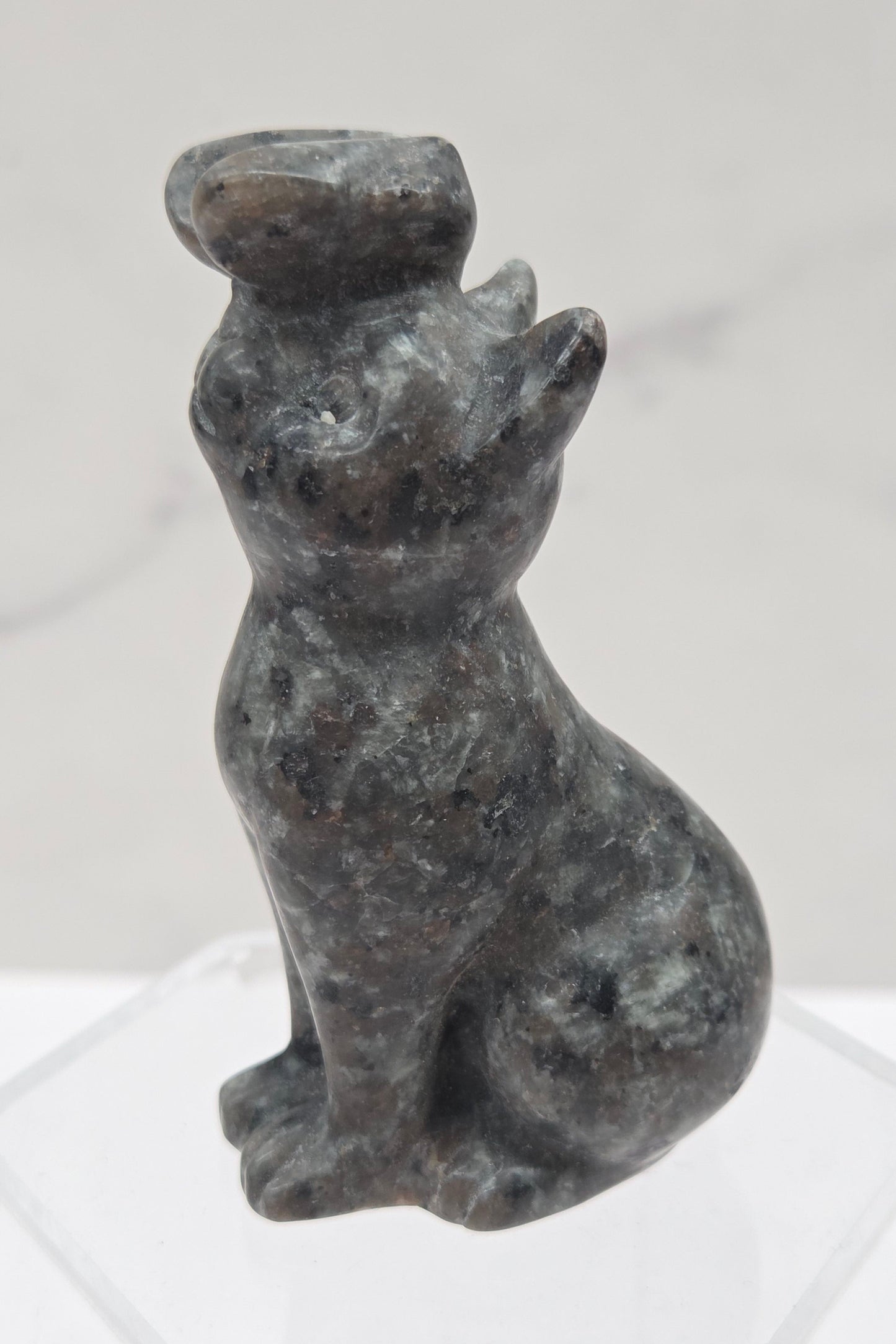 Yooperlite crystal cat-shaped carving with a butterfly on the nose.