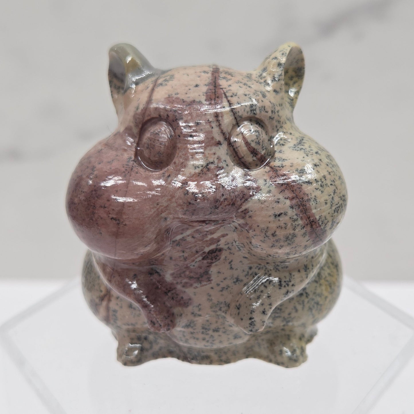 Picture Jasper carving of a chipmunk on an acrylic block against a white background
