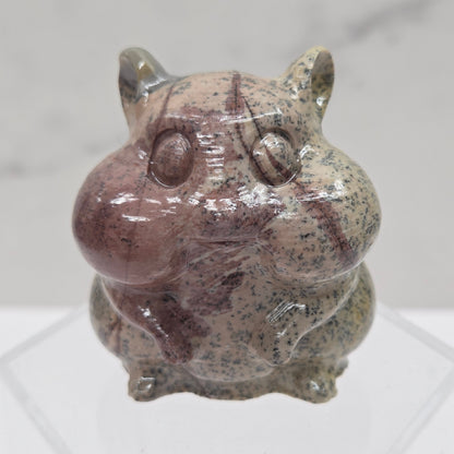 Picture Jasper carving of a chipmunk on an acrylic block against a white background