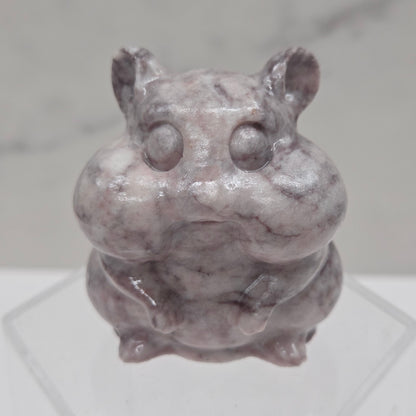 Lavender Jasper carving of a chipmunk on an acrylic block against a white background