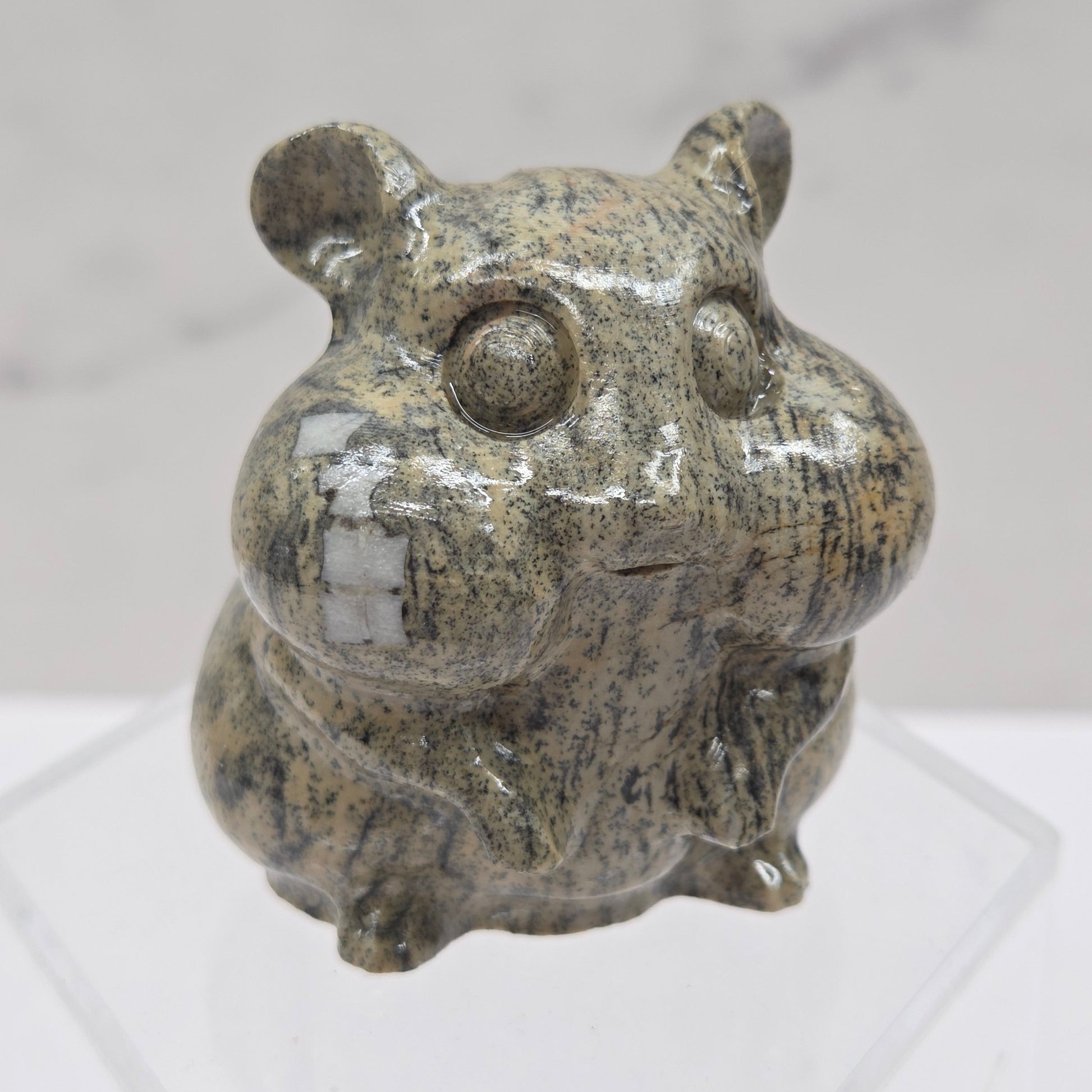 Picture Jasper carving of a chipmunk on an acrylic block against a white background