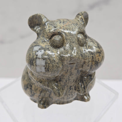 Picture Jasper carving of a chipmunk on an acrylic block against a white background