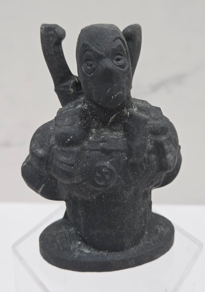 Black stone sculpture of Deadpool on a white background