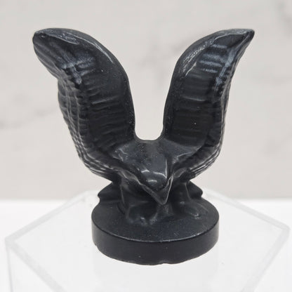 Decorative black winged object on a white background