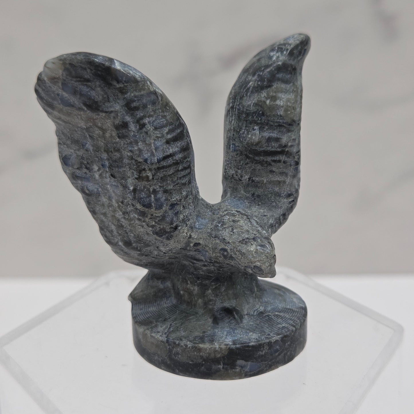 Decorative stone eagle figure on a white background