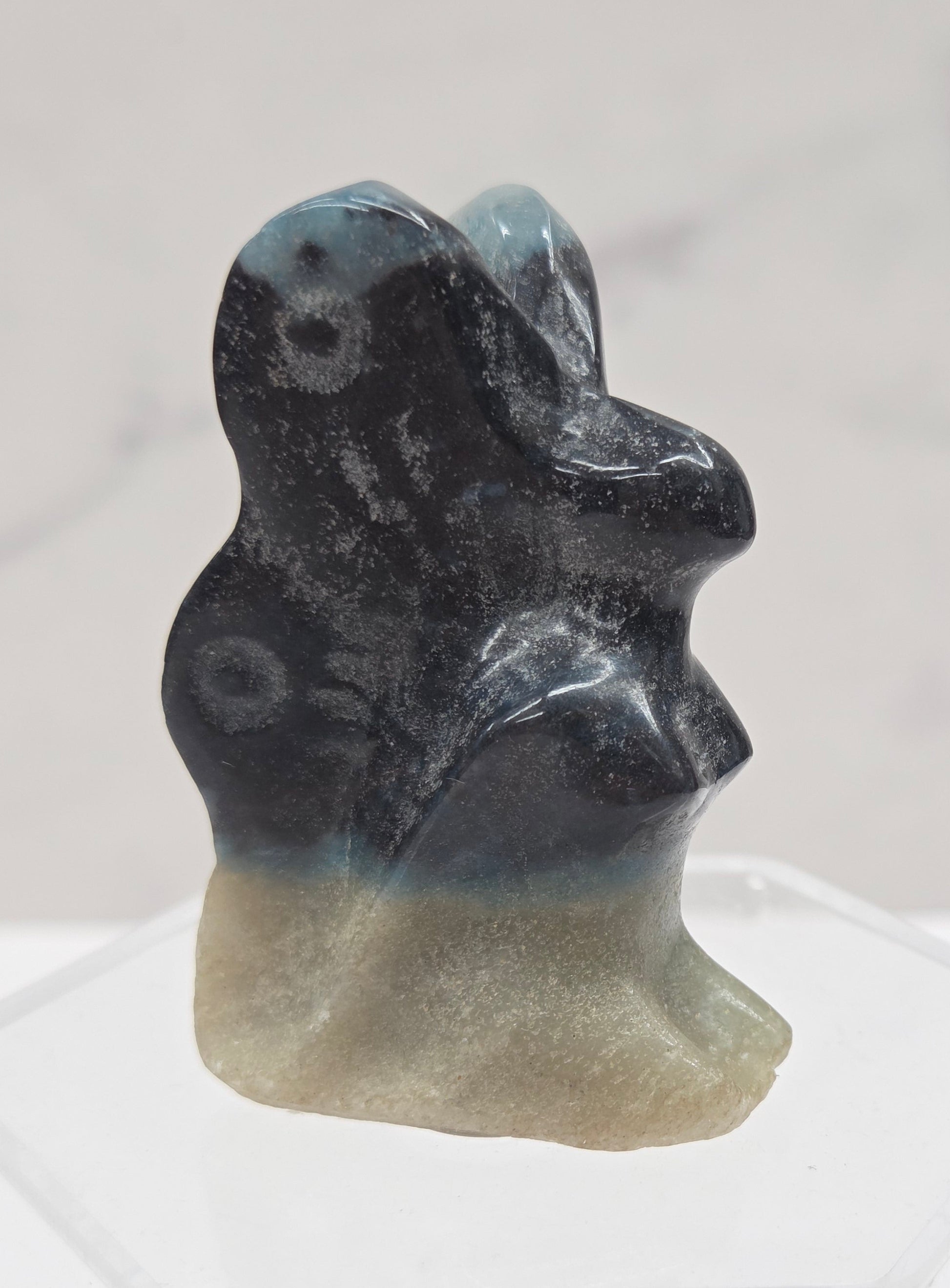 Small stone carving of a fairy on a white background