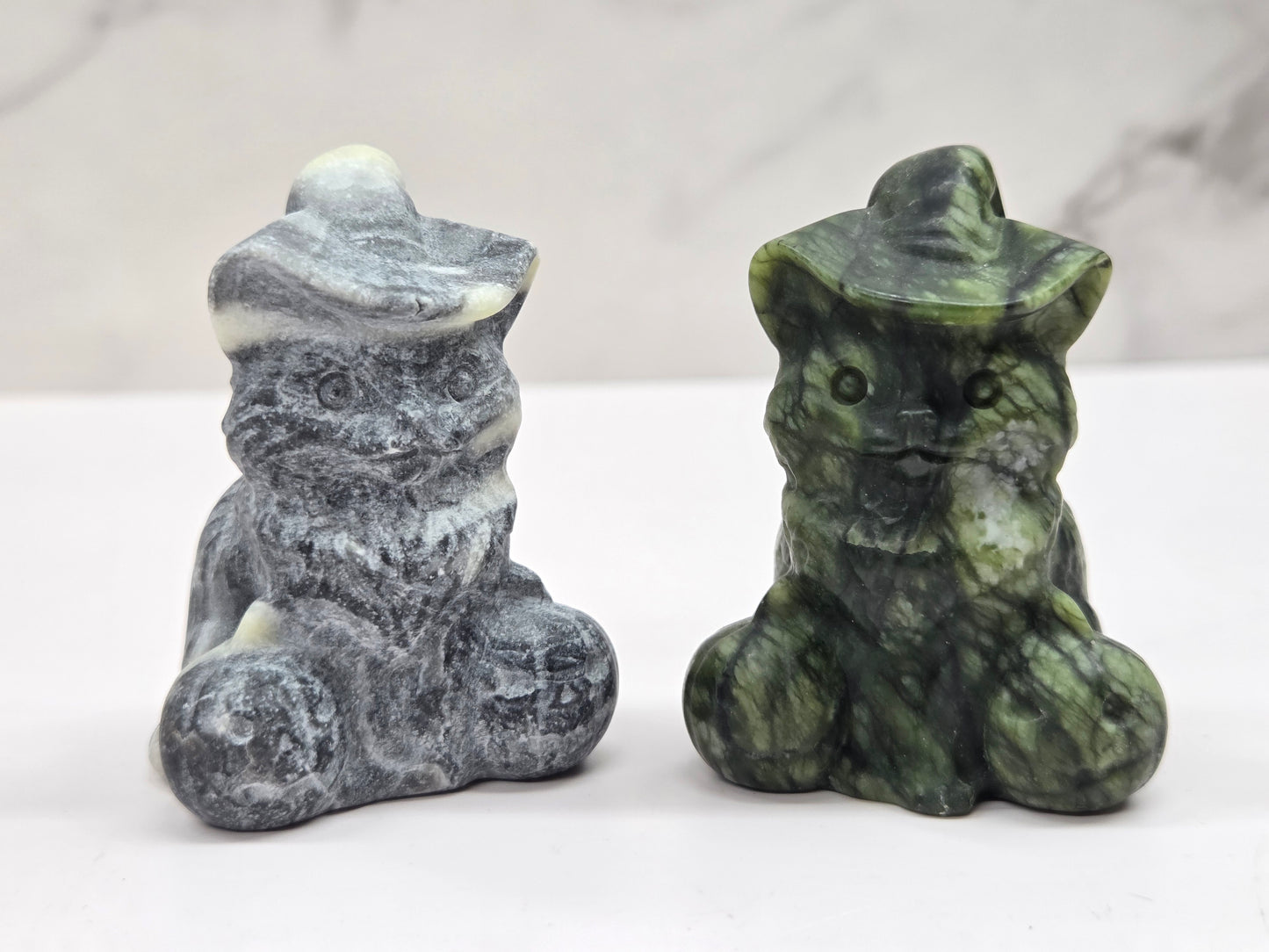cat carvings with pumpkins in gray and green colors, on a neutral background