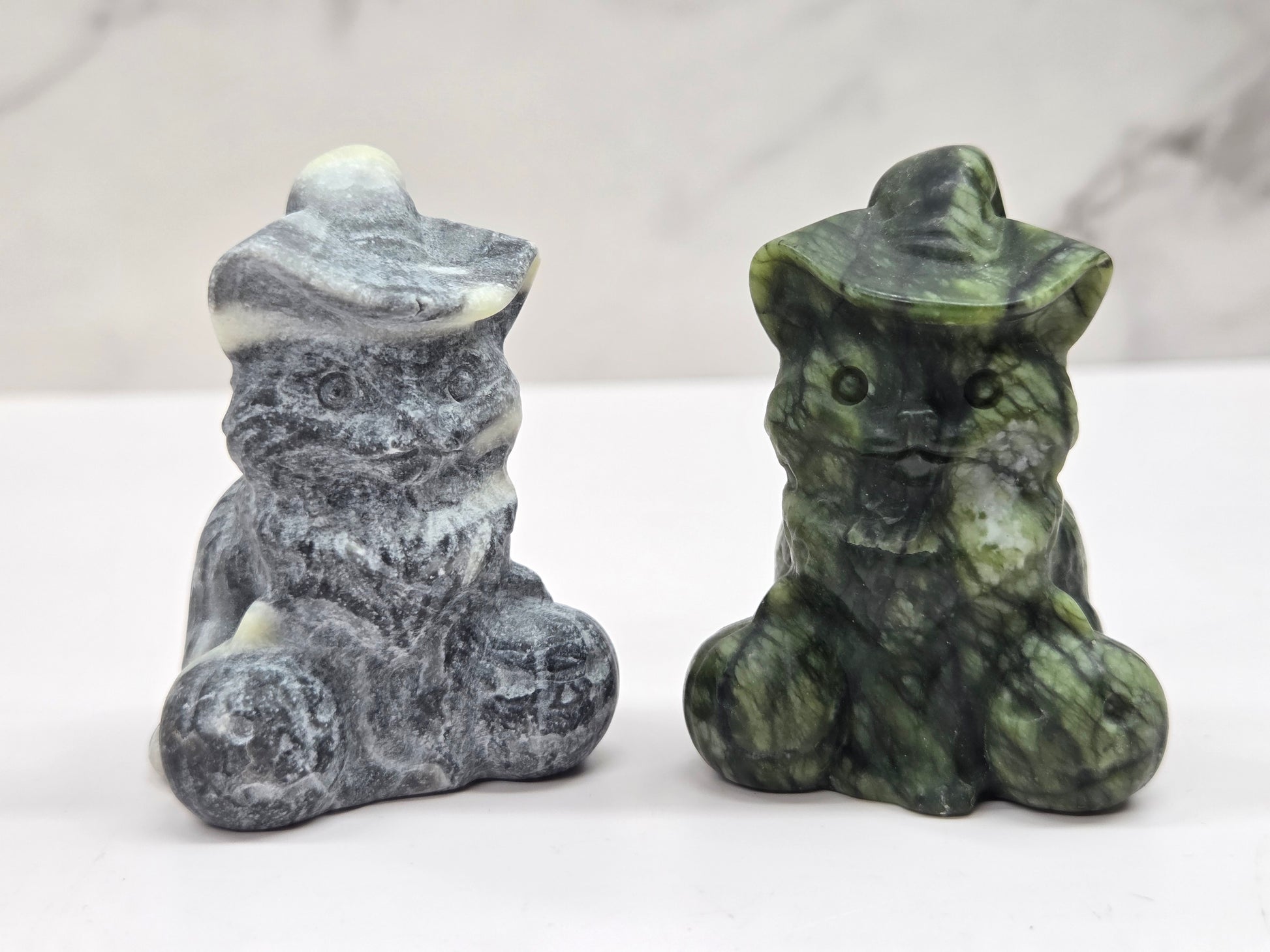 cat carvings with pumpkins in gray and green colors, on a neutral background