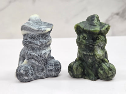 cat carvings with pumpkins in gray and green colors, on a neutral background