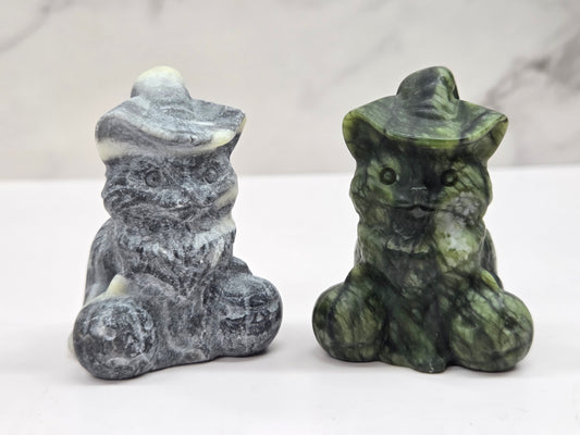 cat carvings with pumpkins in gray and green colors, on a neutral background