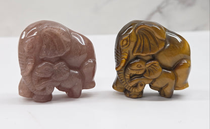 elephant with baby crystal carvings in pink and tan on a neutral background