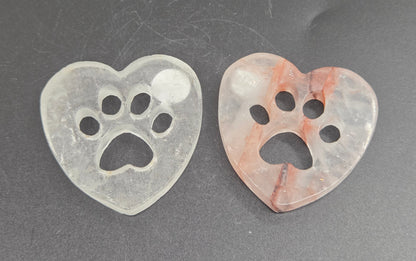 heart carvings with a paw print on a black background