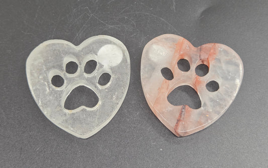 heart carvings with a paw print on a black background