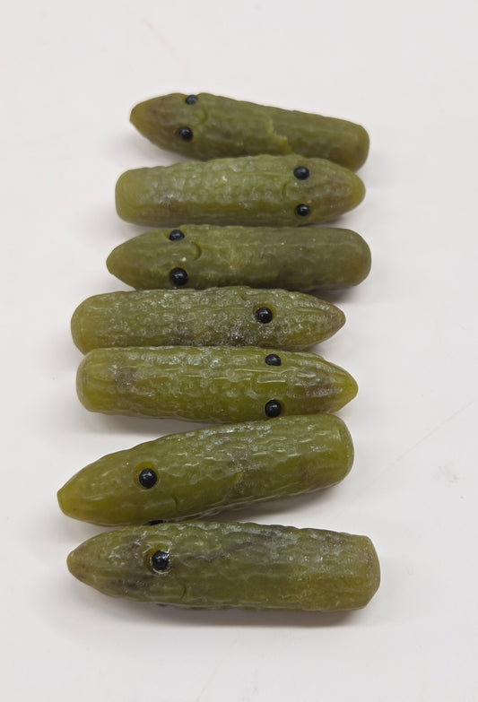 green jade pickle carvings with black eye on a white background