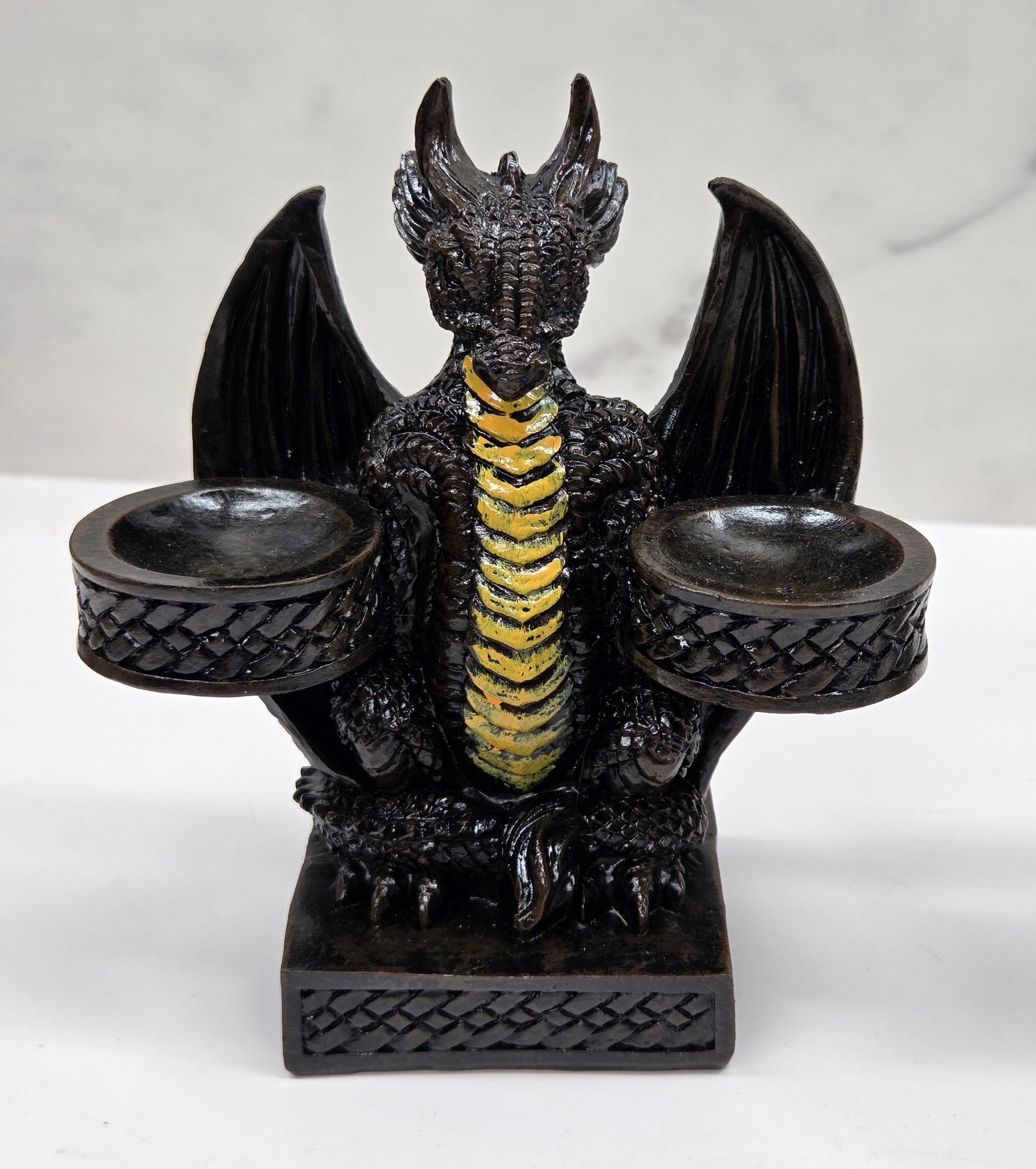 Decorative dragon-shaped sphere holder on a marble surface