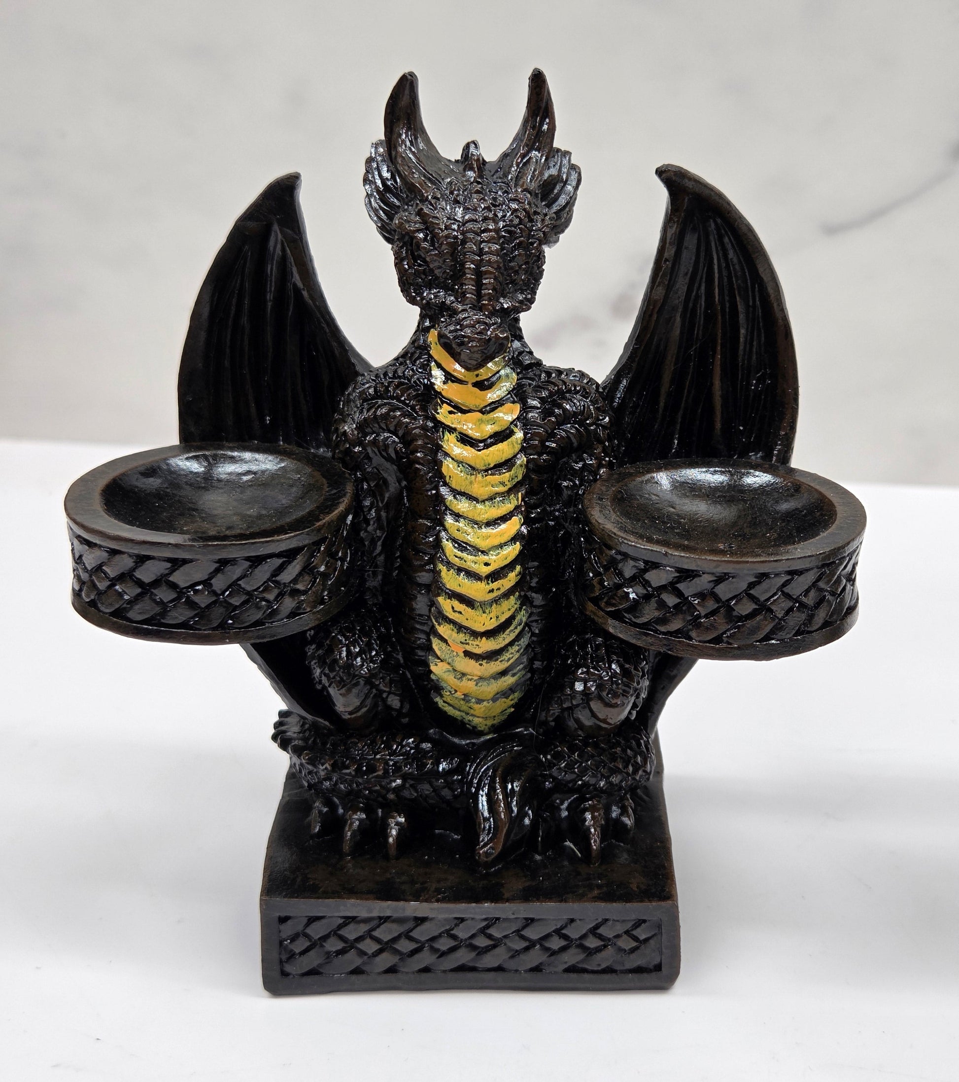 Decorative dragon-shaped sphere holder on a marble surface