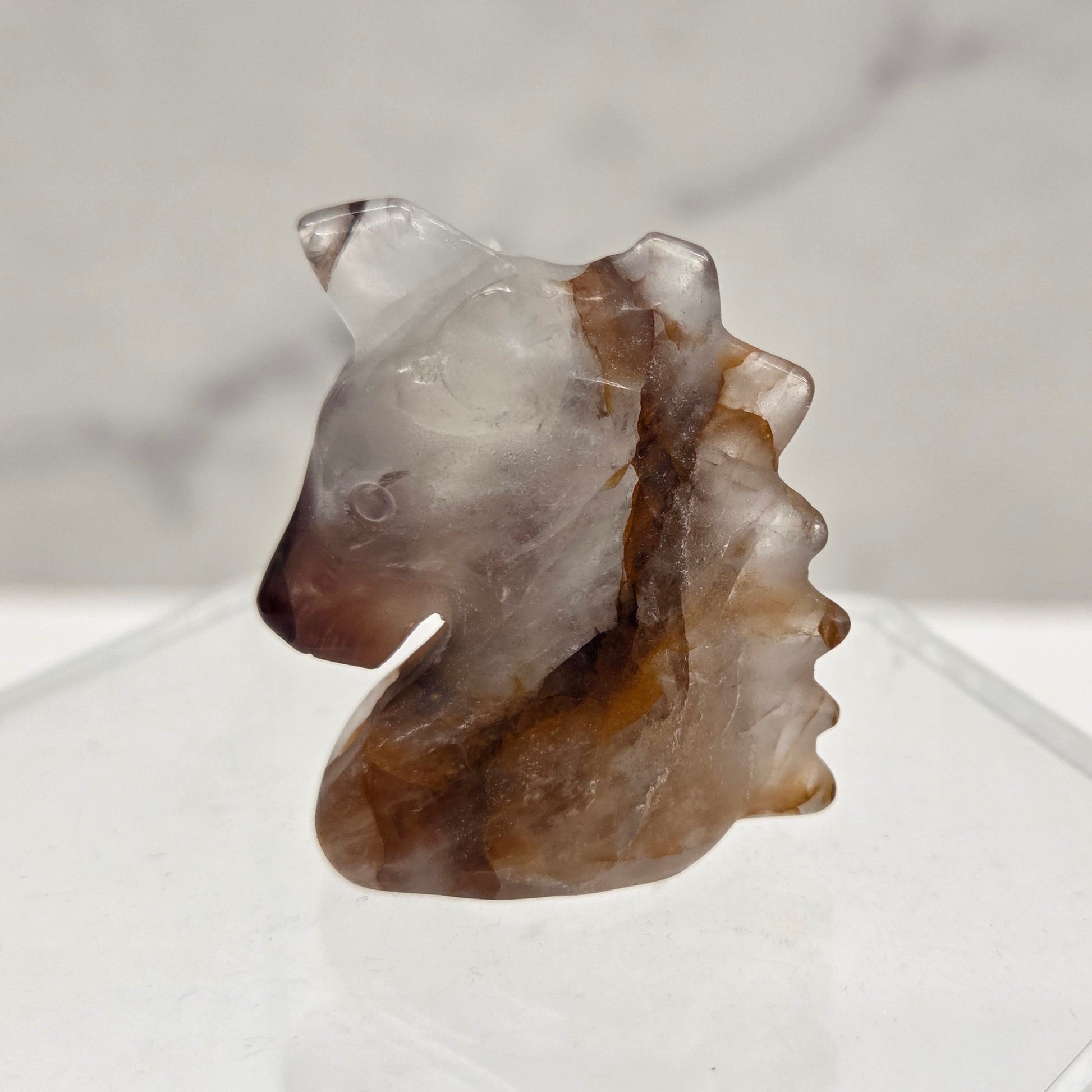 Fire Quartz Unicorn head carving on a white background