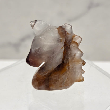 Fire Quartz Unicorn head carving on a white background