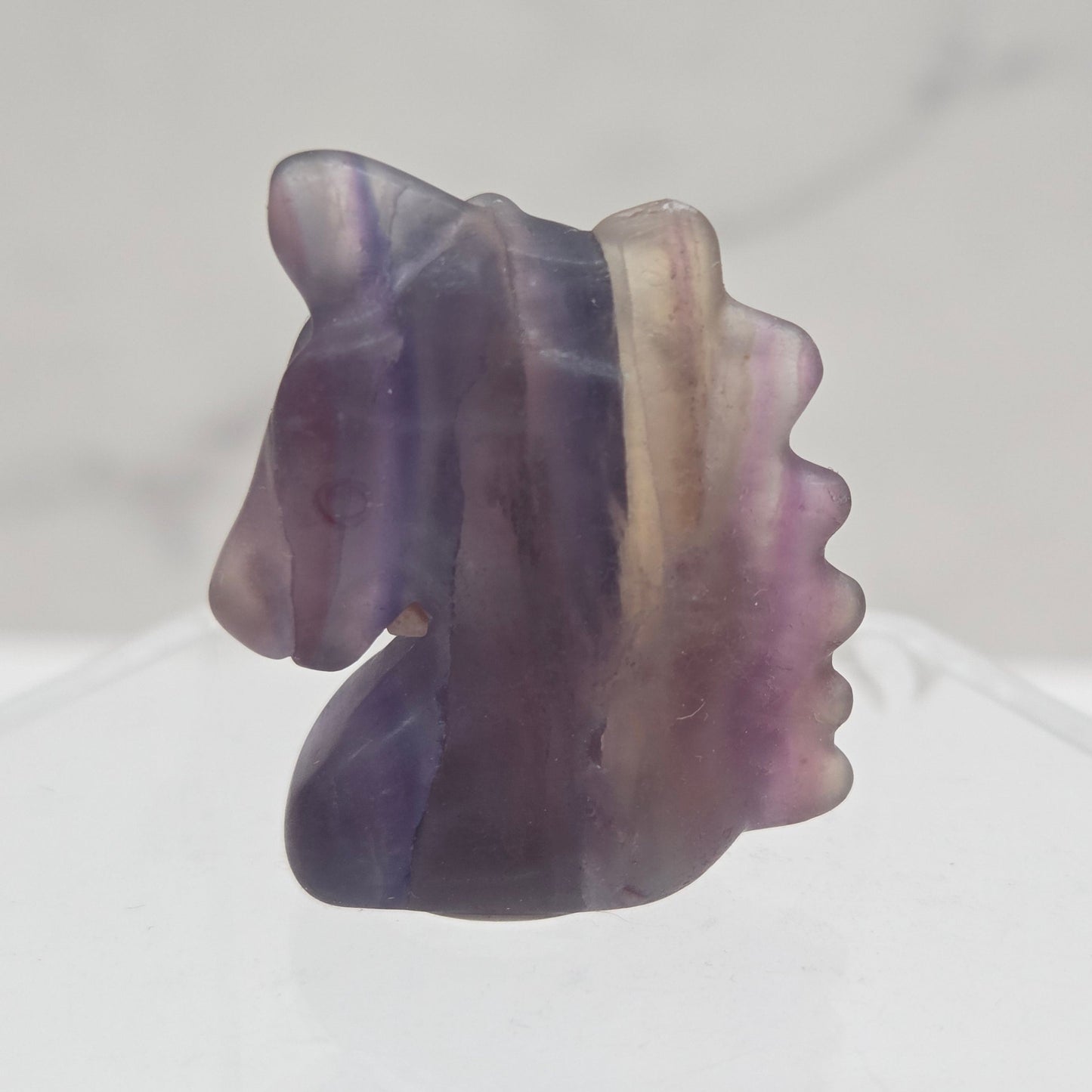 Fluorite Unicorn head carving on a white background