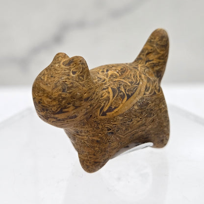 Decorative cat-shaped object with intricate patterns on a white background