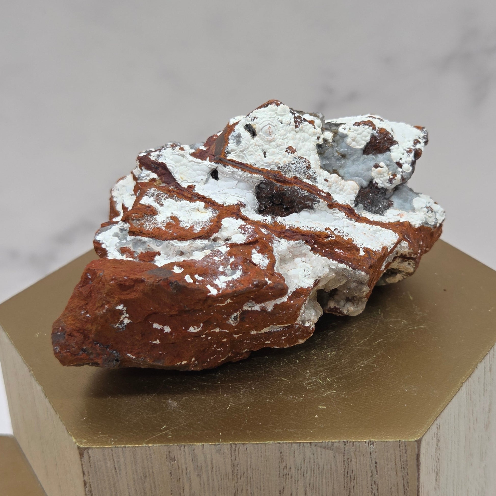 Mineral sample on a wooden stand against a neutral background