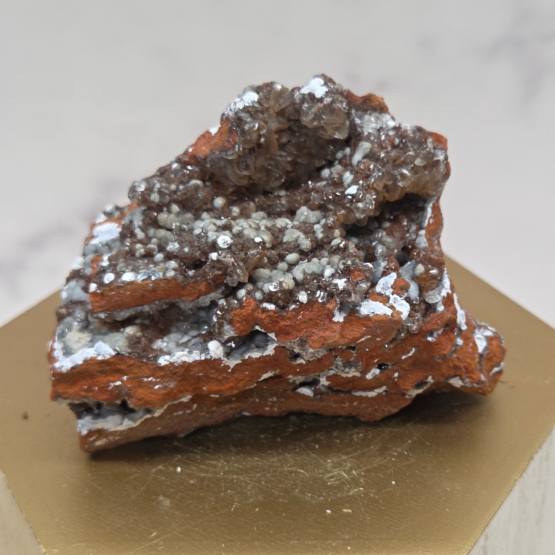 Mineral sample on a wooden stand with a neutral background