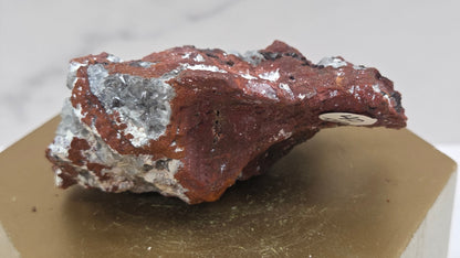 Mineral sample on a wooden stand with a white background