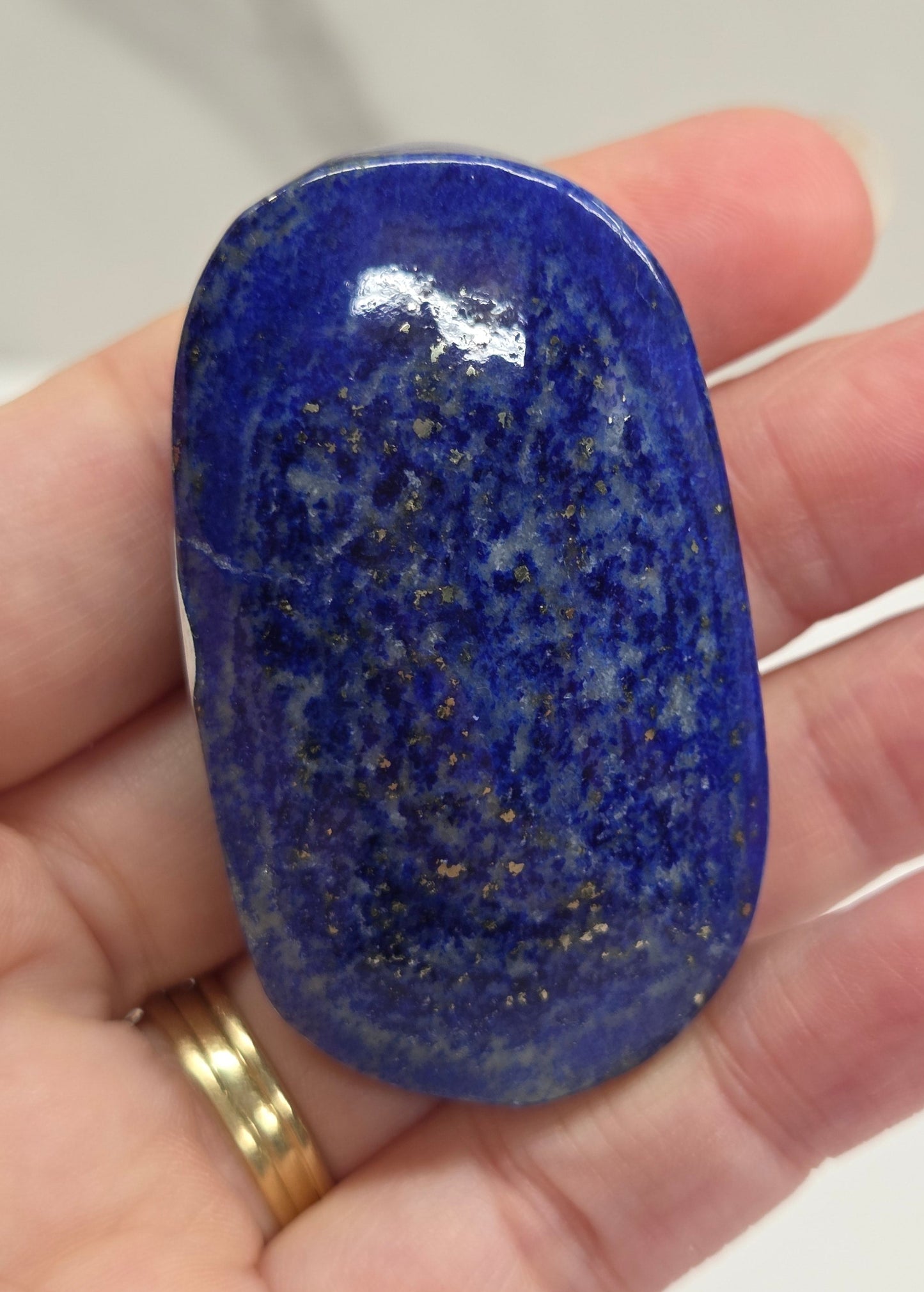 Lapis Lazuli polished palm with white, grey and blue coloring