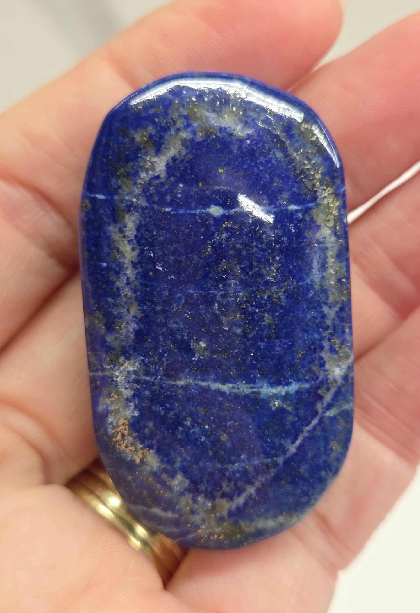 Lapis Lazuli polished palm with white, grey and blue coloring