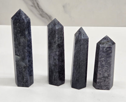 Set of four blue-gray crystal points on a neutral background