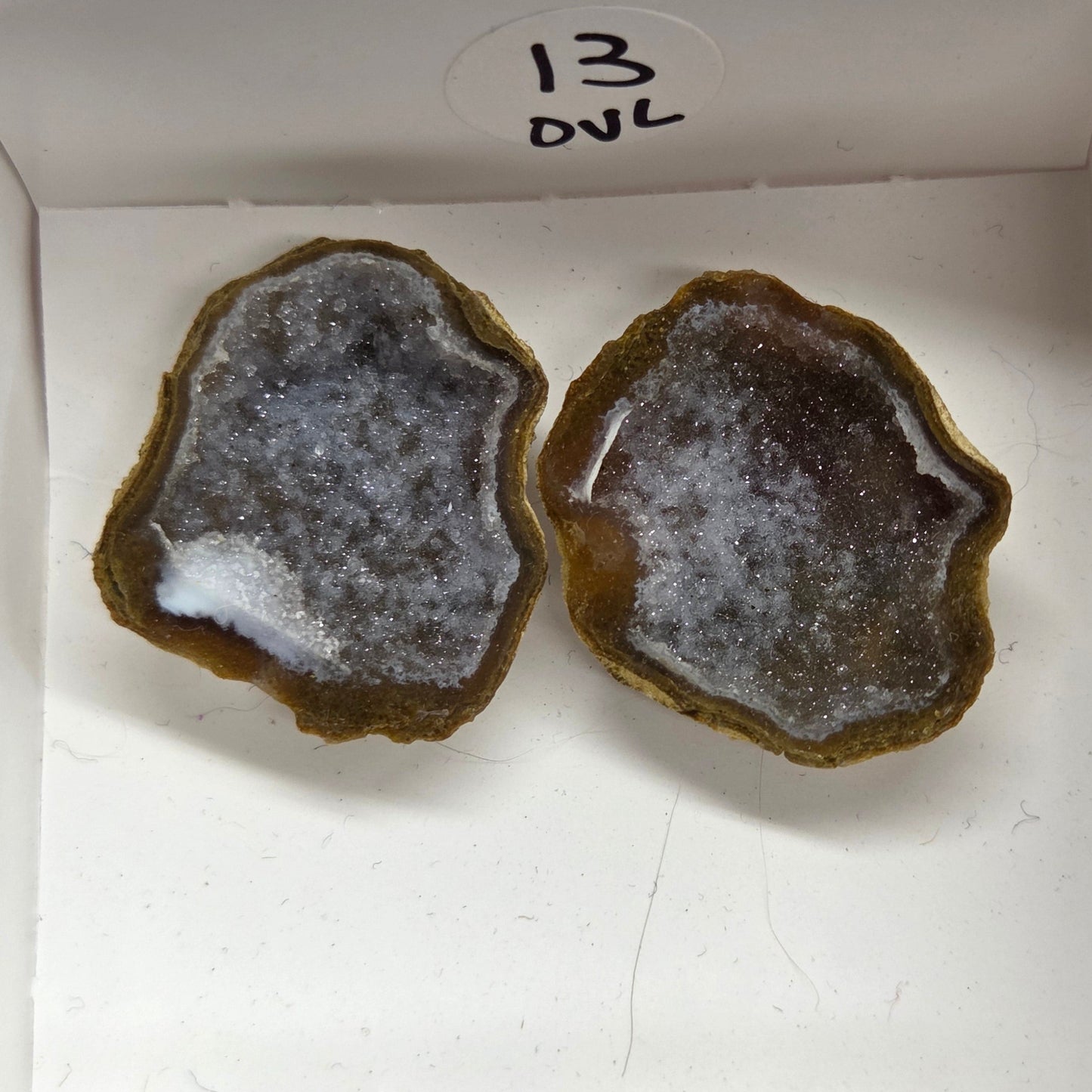 Set of geode crystals in a small white box