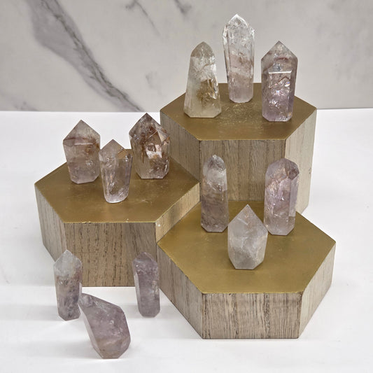 Crystal towers on a wooden stand against a neutral background