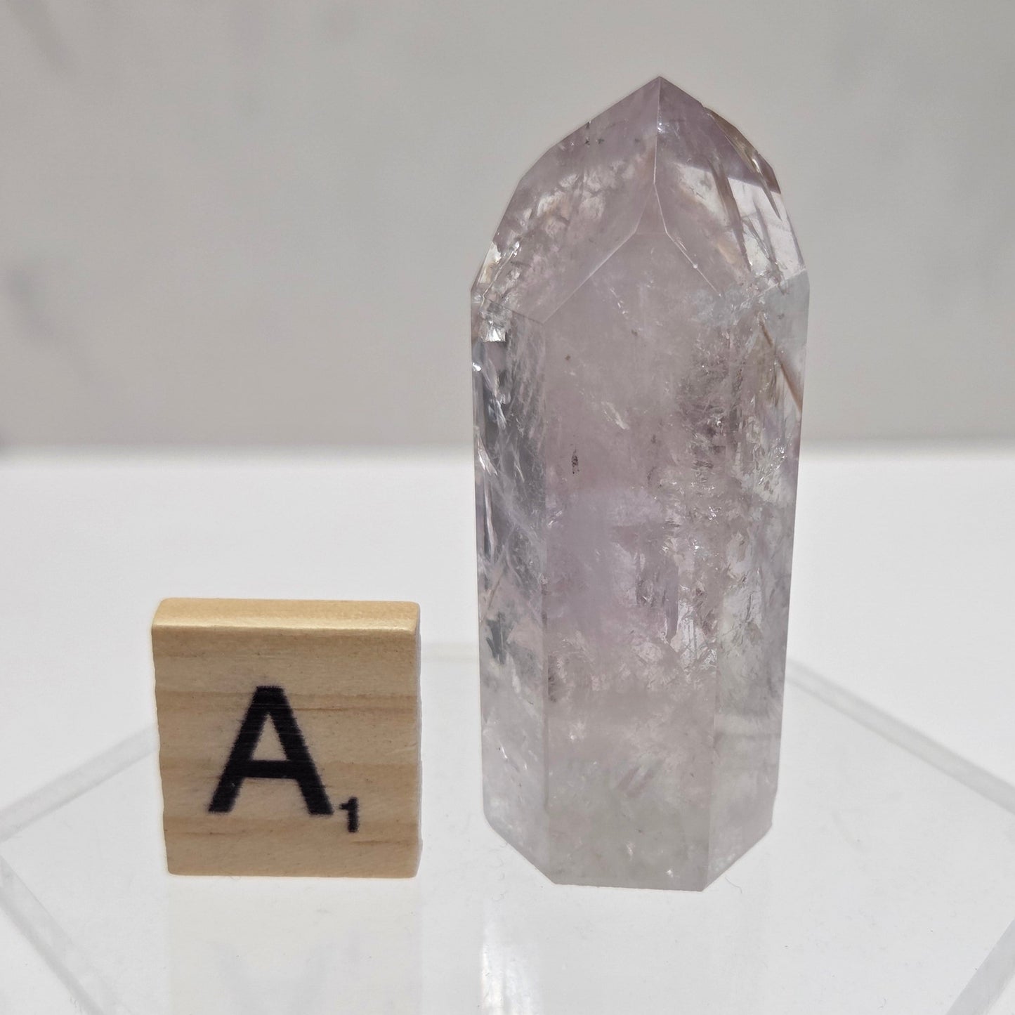 Crystal with a wooden block featuring the letter 'A' on a white background