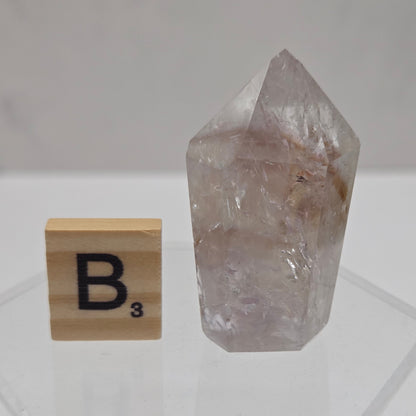 Crystal with a wooden block labeled 'B3' on a white background