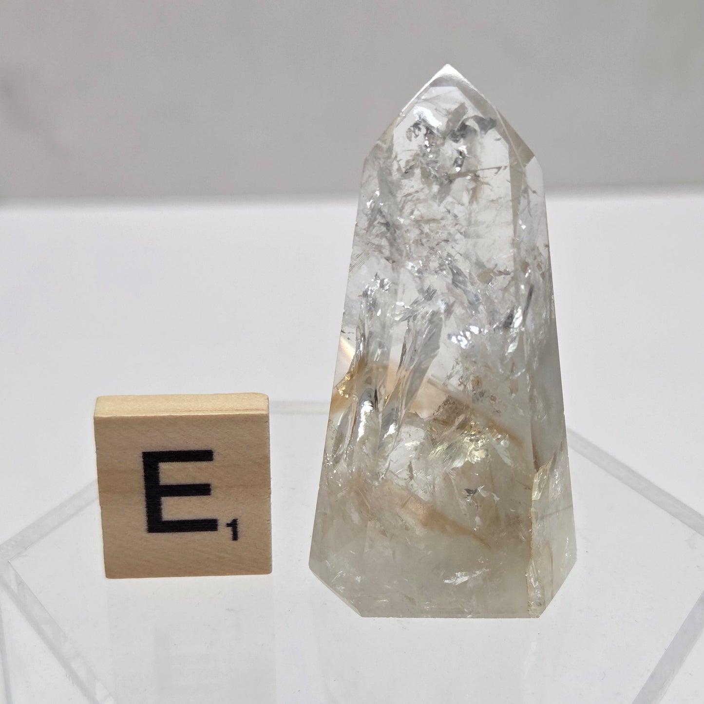 Clear crystal block with a wooden block featuring a symbol on a white background
