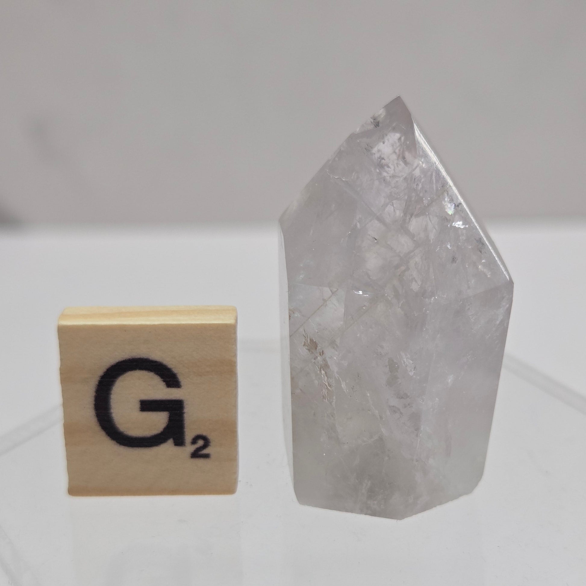 Crystal-like object on a white geometric-patterned surface