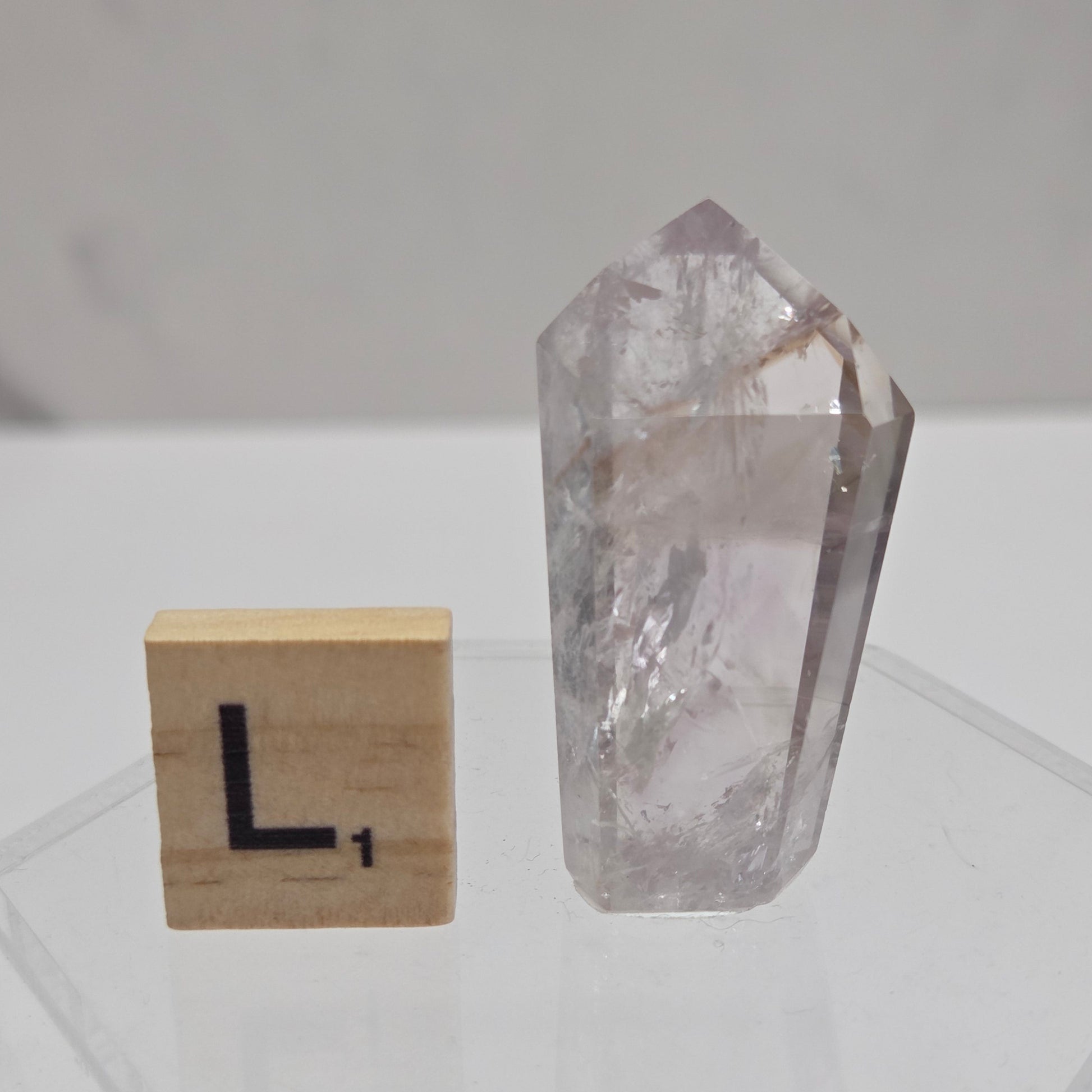 Crystal tower on a white wall with geometric patterns