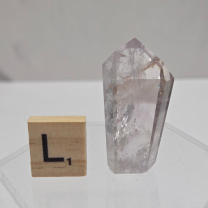 Crystal tower on a white wall with geometric patterns