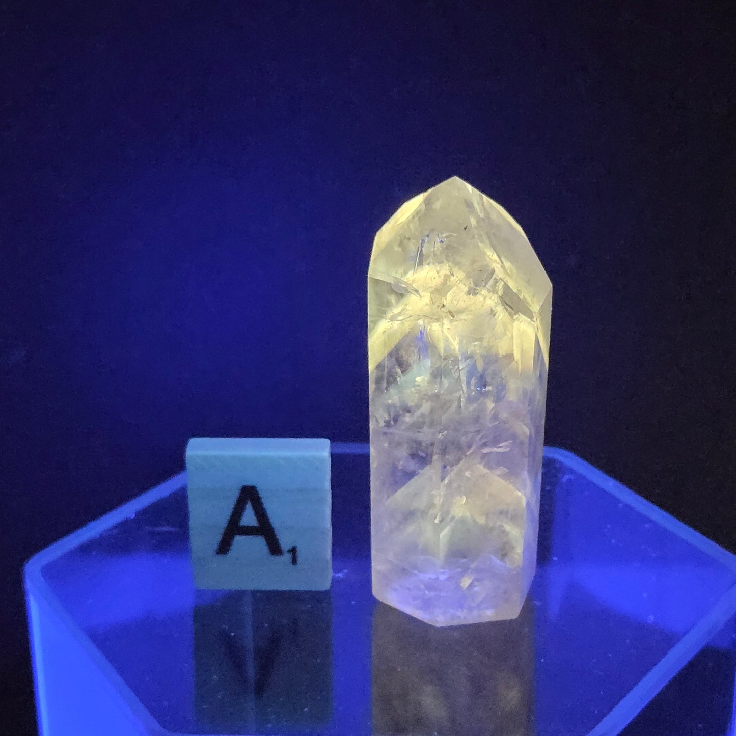 Crystal on a hexagonal stand with a dark background